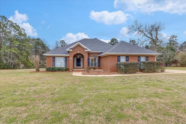 view of front of home featuring brick siding, a front lawn, and roof with shingles