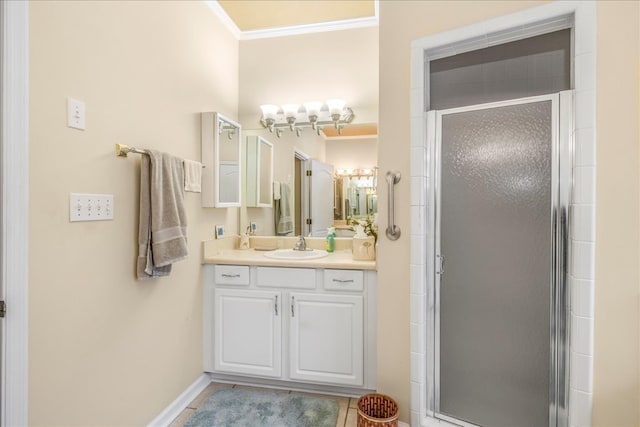 bathroom with crown molding, a shower stall, vanity, tile patterned flooring, and baseboards