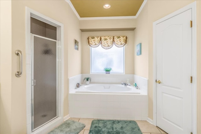 bathroom with a stall shower, a garden tub, crown molding, and tile patterned floors