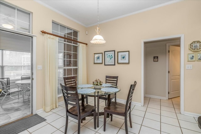 dining room with ornamental molding, baseboards, and light tile patterned floors