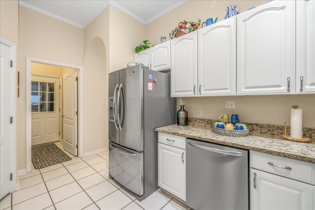 kitchen featuring appliances with stainless steel finishes, ornamental molding, light stone countertops, white cabinetry, and light tile patterned flooring