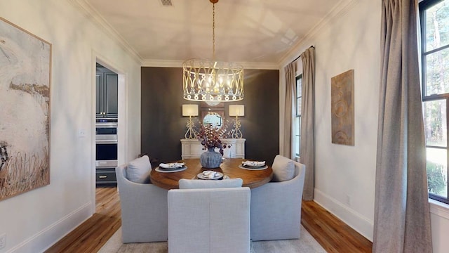 7827 Metcalf Rd, Thomasville, GA 31792 - dining area featuring a chandelier, wood finished floors, healthy amount of natural light, and ornamental molding