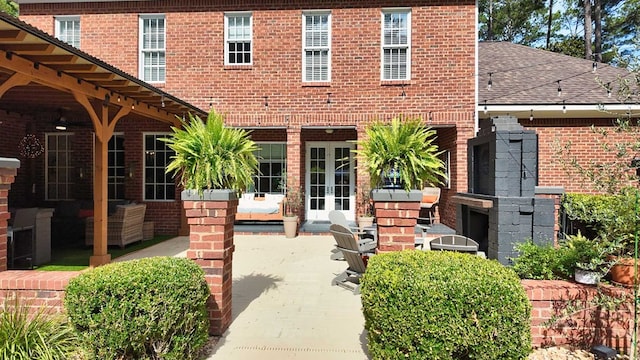 7827 Metcalf Rd, Thomasville, GA 31792 - property entrance featuring french doors, brick siding, a patio area, and a shingled roof