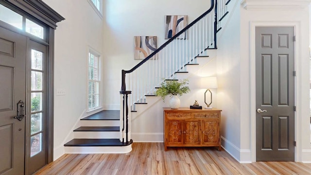 7827 Metcalf Rd, Thomasville, GA 31792 - entryway featuring light wood-style flooring, stairway, healthy amount of natural light, and a high ceiling