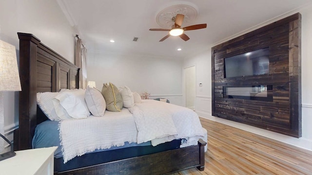 7827 Metcalf Rd, Thomasville, GA 31792 - bedroom with light wood-style flooring, ceiling fan, recessed lighting, a wainscoted wall, and ornamental molding