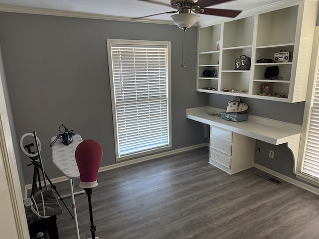 office area with ceiling fan, ornamental molding, dark hardwood / wood-style floors, and built in desk