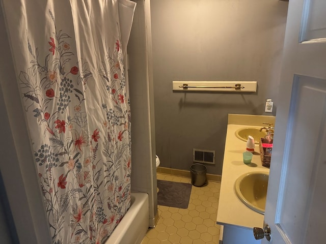 full bathroom with vanity, toilet, tile patterned flooring, and shower / bath combo with shower curtain