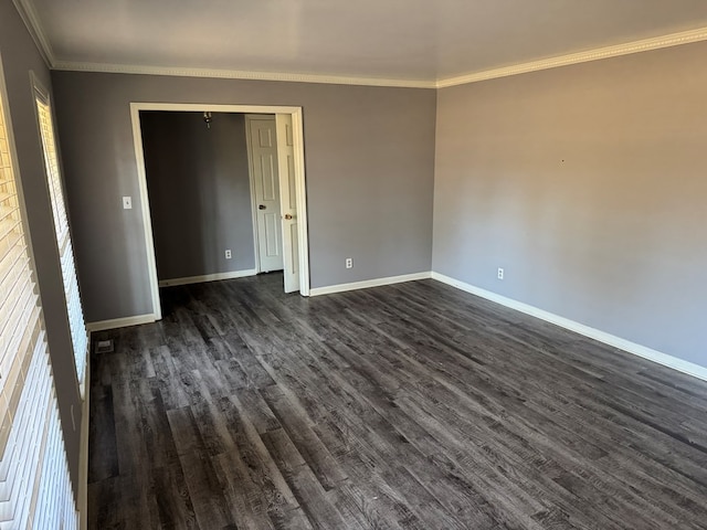 unfurnished room featuring dark wood-type flooring and ornamental molding