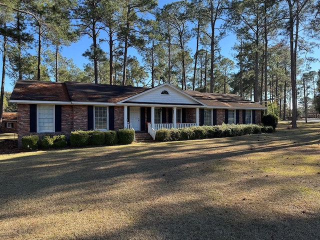 ranch-style home with a porch and a front lawn