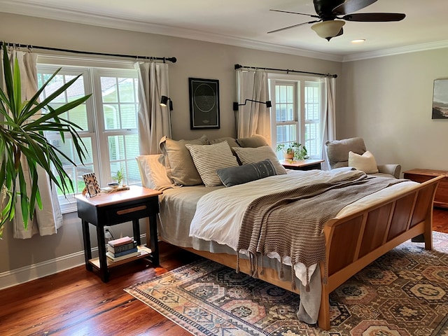 bedroom with a ceiling fan, crown molding, baseboards, and dark wood-style flooring