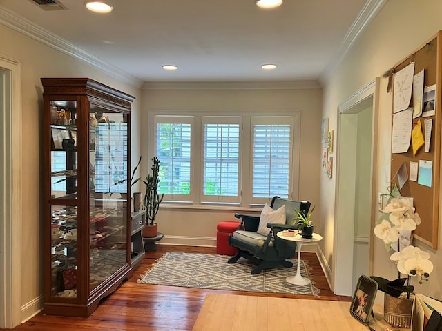 sitting room with crown molding, recessed lighting, wood finished floors, and baseboards