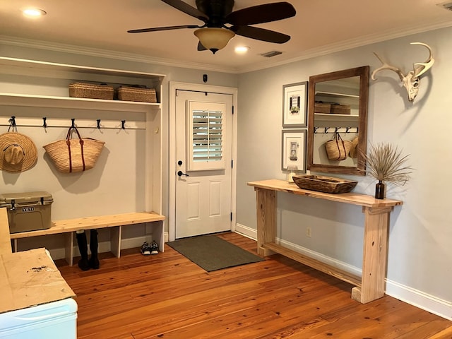 mudroom with hardwood / wood-style floors, a ceiling fan, baseboards, visible vents, and crown molding