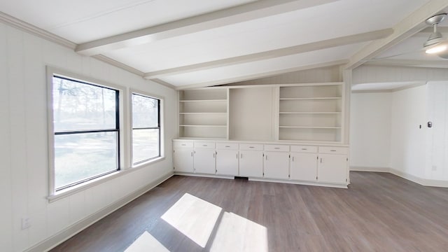 spare room featuring lofted ceiling with beams, built in features, baseboards, and light wood finished floors