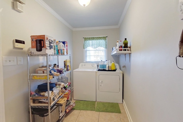 washroom with crown molding, independent washer and dryer, and light tile patterned floors