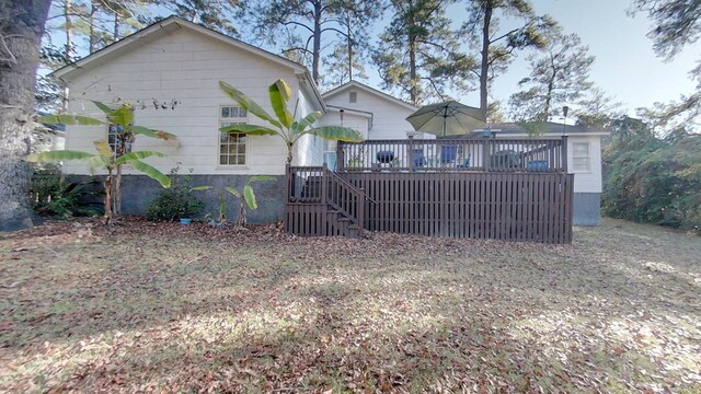 back of property featuring a deck