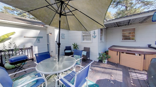 view of patio featuring a wooden deck, grilling area, and a hot tub