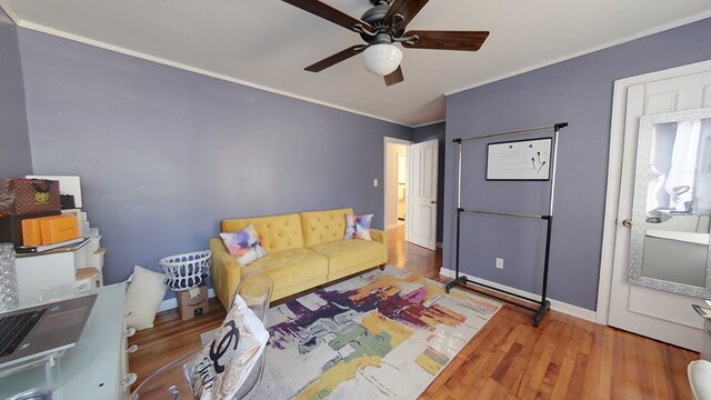 living room featuring crown molding, ceiling fan, and hardwood / wood-style floors