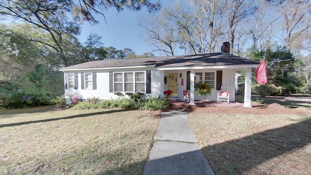 single story home featuring covered porch and a front lawn