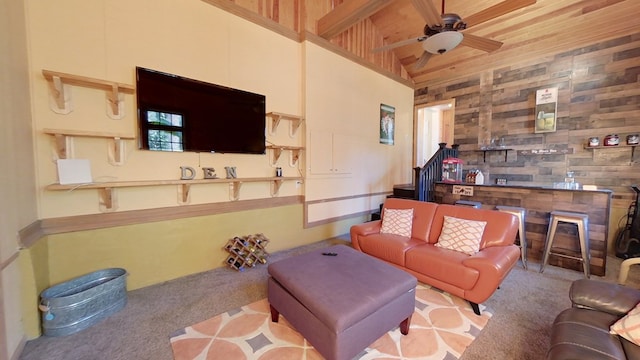 living room with wood ceiling, ceiling fan, a fireplace, and light carpet