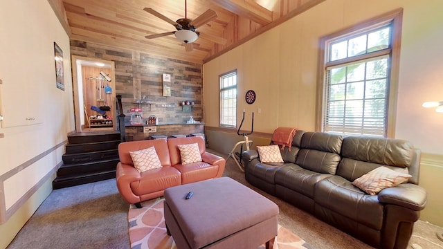 living room with light colored carpet, vaulted ceiling, wooden ceiling, wooden walls, and ceiling fan