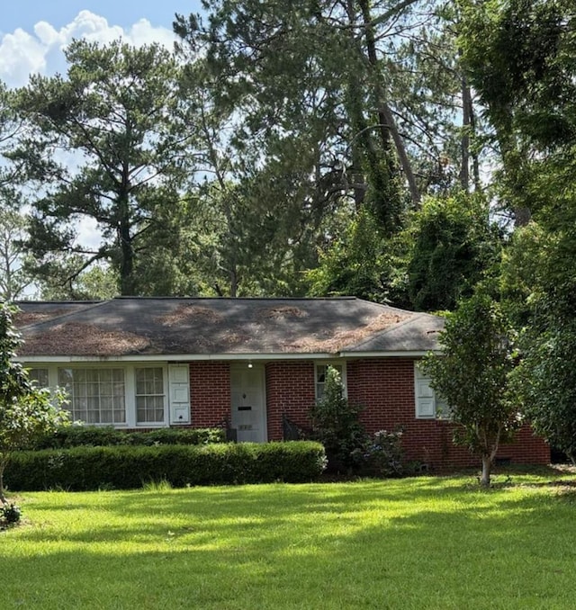 221 Maury St, Thomasville, GA 31792 - ranch-style home featuring a front yard and brick siding