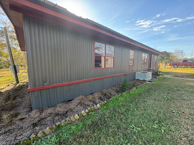 view of property exterior featuring cooling unit and a yard