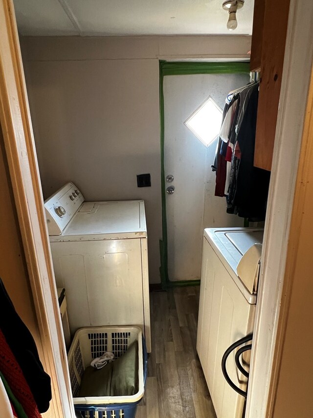 washroom featuring washing machine and dryer and wood-type flooring