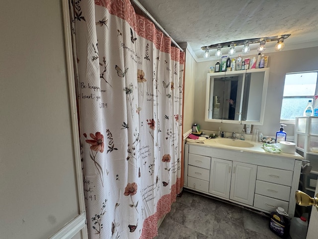 bathroom featuring crown molding, vanity, a shower with shower curtain, and a textured ceiling