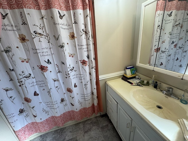 bathroom featuring vanity and curtained shower