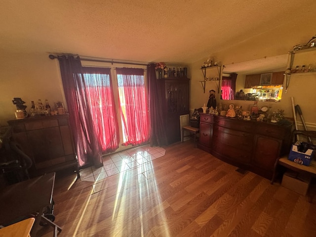 interior space with vaulted ceiling, hardwood / wood-style floors, and a textured ceiling