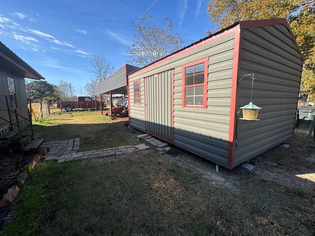 exterior space featuring a yard and an outbuilding