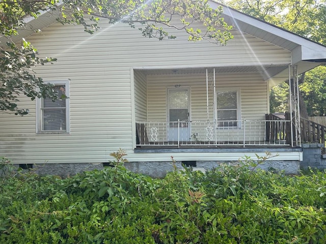 back of house featuring a porch