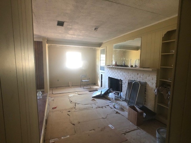 unfurnished living room featuring a brick fireplace