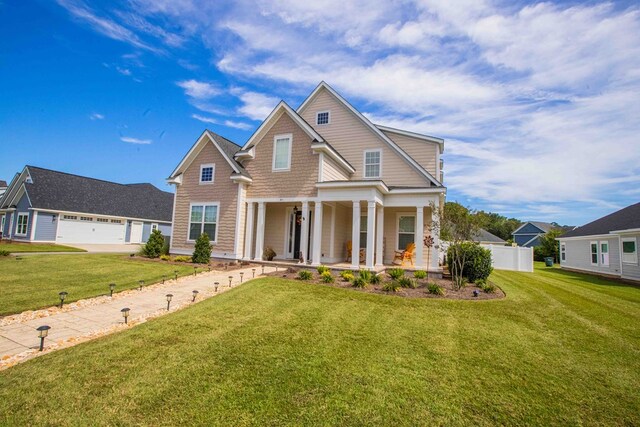 craftsman-style house featuring a porch, a garage, and a front lawn