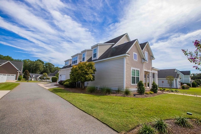 view of home's exterior featuring a garage and a lawn