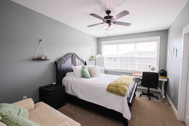 bedroom featuring dark carpet and ceiling fan