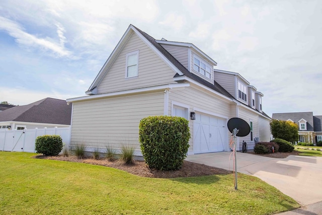 view of home's exterior with a garage and a lawn