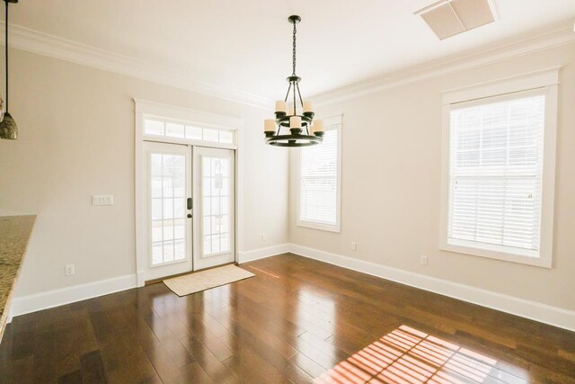 interior space featuring dark wood-type flooring, ornamental molding, french doors, and a notable chandelier