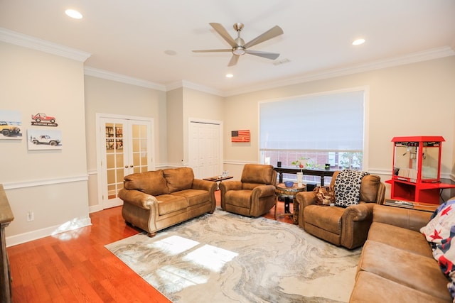 living room with french doors, visible vents, wood finished floors, and ornamental molding