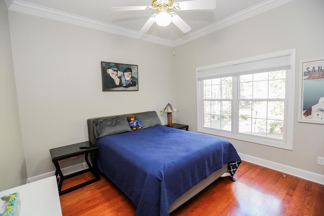 bedroom featuring baseboards, wood finished floors, a ceiling fan, and ornamental molding