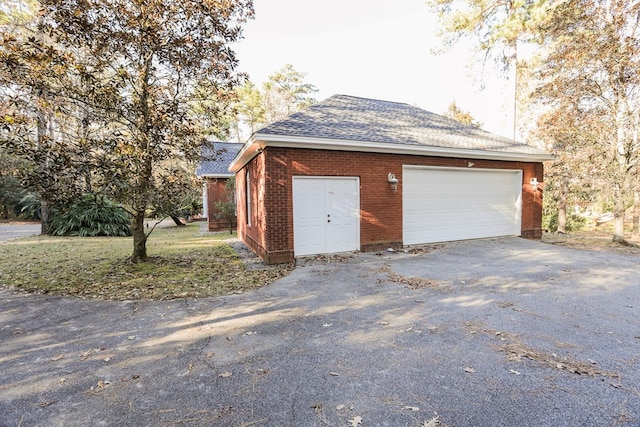 garage featuring aphalt driveway