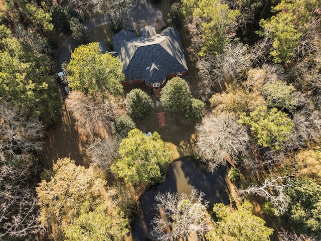 bird's eye view with a wooded view