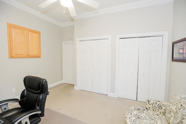 office area featuring ornamental molding, a ceiling fan, and light carpet