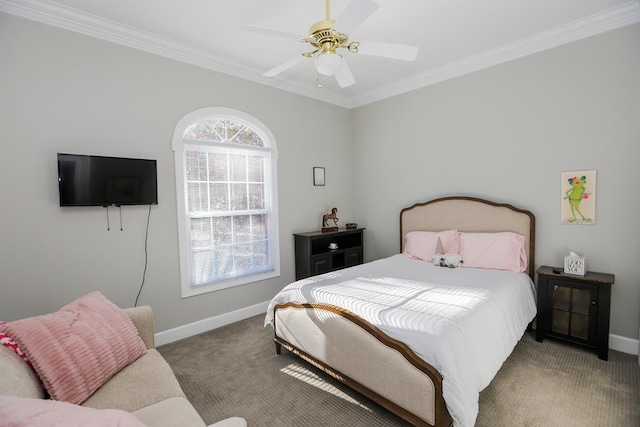 carpeted bedroom with ceiling fan, crown molding, and baseboards