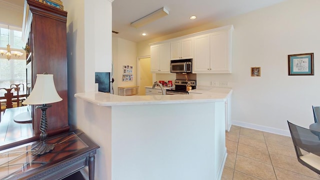 139 Summercreek Cv, Thomasville, GA 31792 - kitchen featuring stainless steel appliances, light tile patterned floors, white cabinetry, recessed lighting, and light countertops