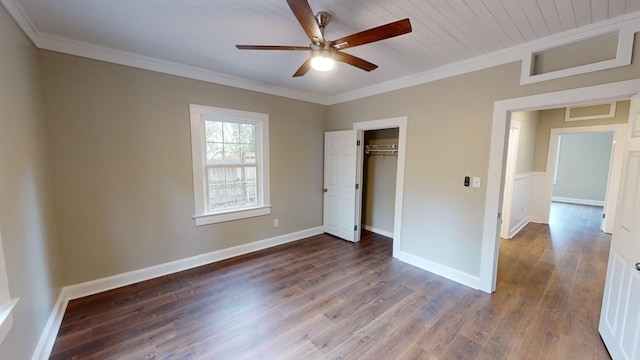 unfurnished bedroom featuring crown molding, ceiling fan, dark wood-type flooring, and a closet