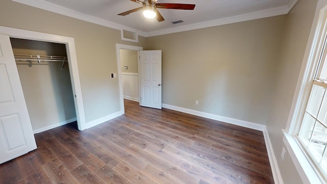 unfurnished bedroom featuring ceiling fan, ornamental molding, dark hardwood / wood-style floors, and a closet