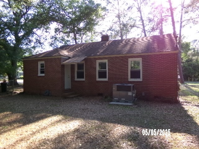 320 Camellia Ct, Camilla, GA 31730 - rear view of house featuring a chimney, cooling unit, and brick siding