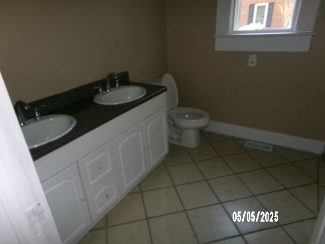 320 Camellia Ct, Camilla, GA 31730 - bathroom with toilet, tile patterned flooring, baseboards, and a sink