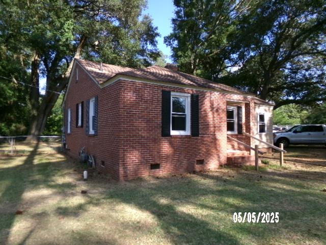 320 Camellia Ct, Camilla, GA 31730 - view of side of property with a yard, fence, brick siding, and crawl space